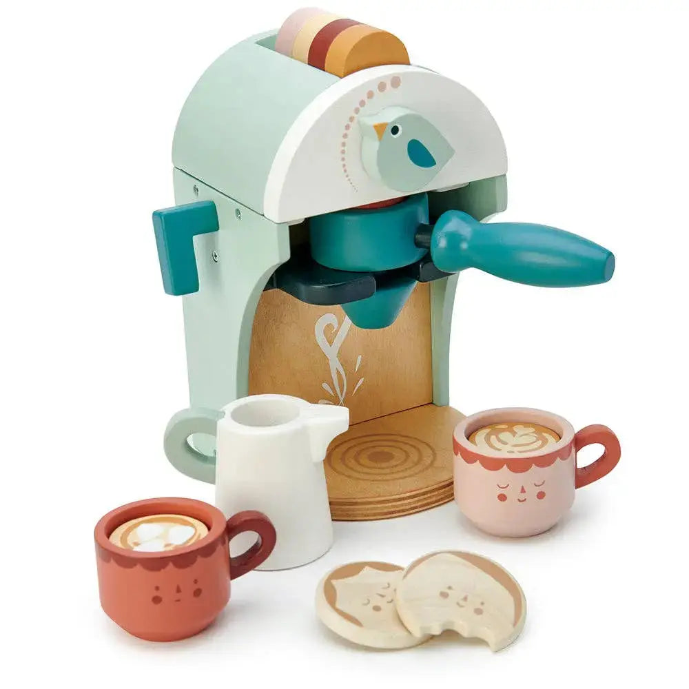 Babyccino Kaffeemaschine aus Holz mit Tassen, Kapseln, Milchkännchen und Keksen.